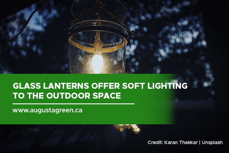 Glass lanterns offer soft lighting to the outdoor space